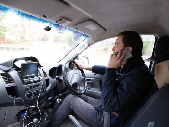 Ev posing with mobile phone while parked in his HiLux