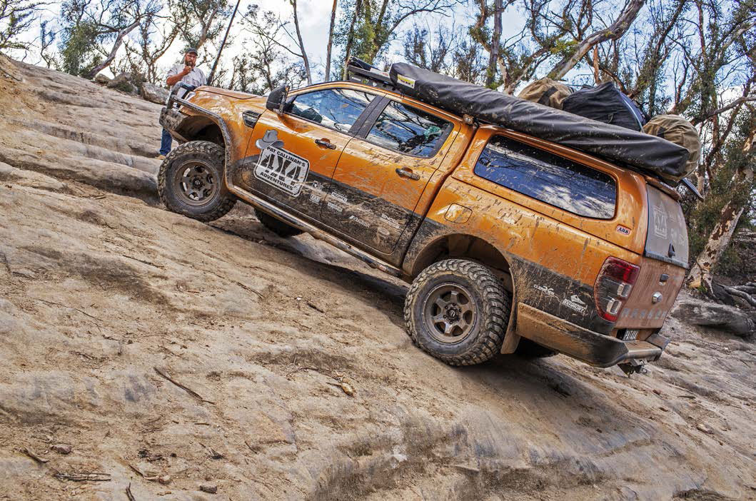 Ford Ranger climbing a two-step rocky ledge